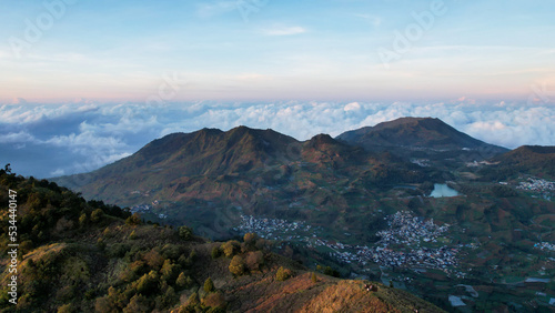 Aerial view of beauty mountain peaks Prau Dieng, Central Java and the climbers and tent. 