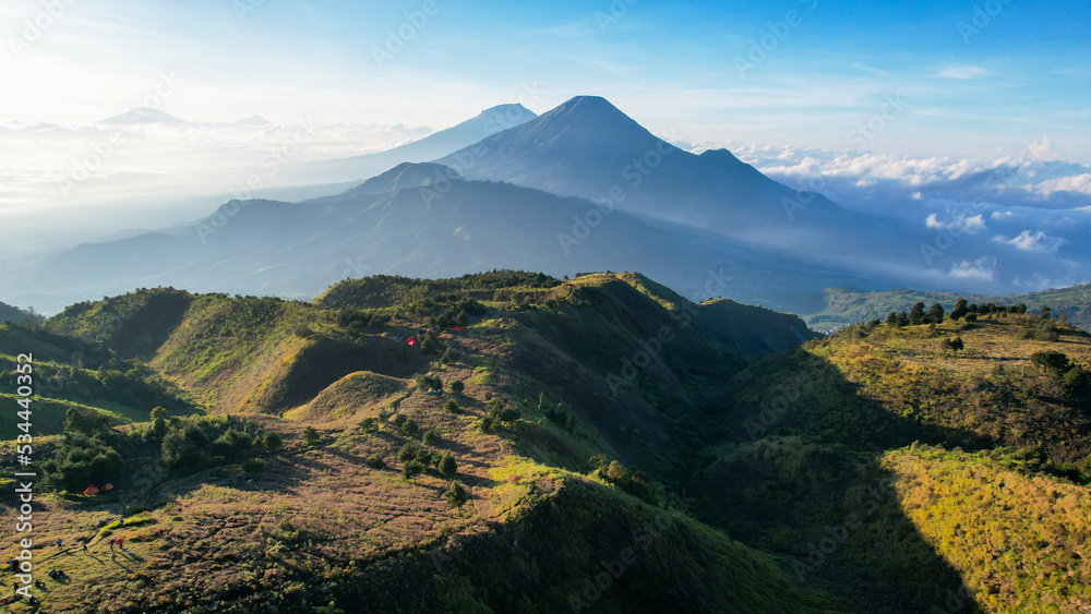 Aerial view of beauty mountain peaks Prau Dieng, Central Java and the climbers and tent. 