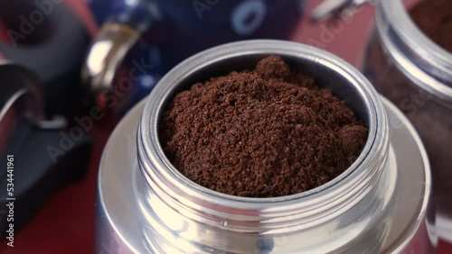 The process of making coffee in Italian moka pot – ground coffee put inside a moka pot close up
