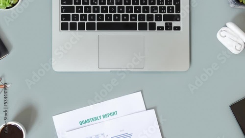 Modern office desktop with laptop, succulent plants, documents and gadget’s top view. Working on quarterly reports with coffee cup. Smark working at home. Stopmotion