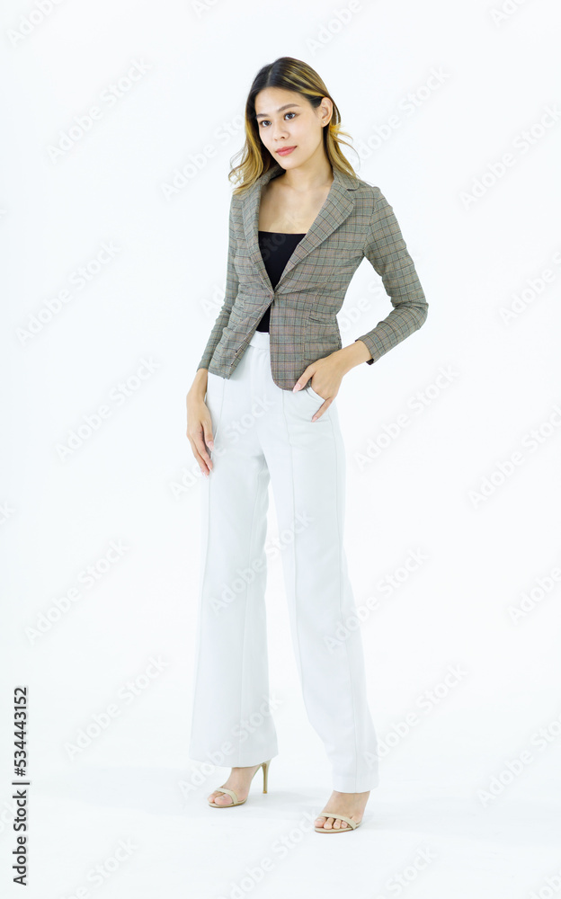 Isolated cutout studio full body shot Millennial Asian successful professional female businesswoman in formal suit standing smiling posing on blank empty space on white background Isolated cutout studio full body shot Millennial Asian successful professional female businesswoman in formal suit standing smiling posing on blank empty space on white background