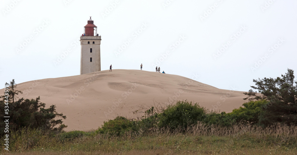 Lokken, Denmark - August 24, 2022: People at the popular Rubjerg Knude Lighthouse in Jutland. Lokken, Denmark - August 24, 2022: People at the popular Rubjerg Knude Lighthouse in Jutland.