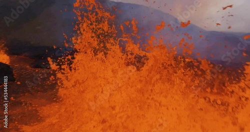 FPV drone shot through a raging and splashing volcano lava fountain - Slow motion photo