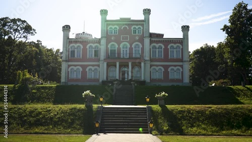 Birinu Palace, Latvian Castle by Lake With Nice Garden. Birini Manor, Vidzeme Region, Latvia. Stedicam Shot Autumn Sunny Day. Camera Moves Forward photo