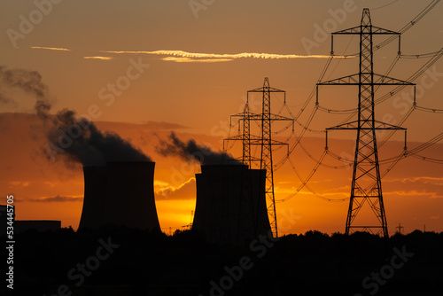 Canvas Print Silhouette of a power station's cooling towers against a beautiful Autumn sunset near Drax in North Yorkshire, UK, with electricity pylons and plumes of water vapour rising from the cooling towers