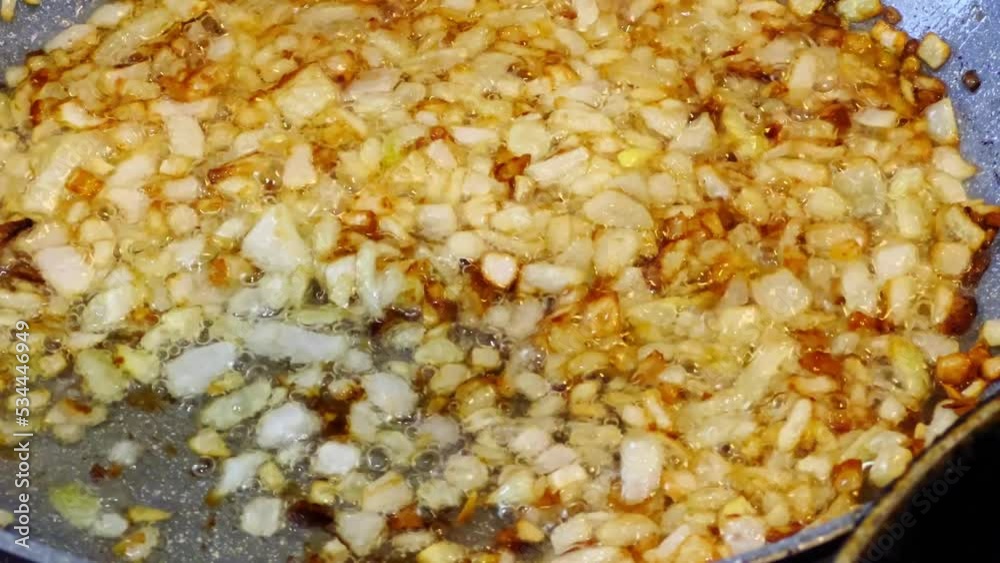 Frying in oil and stirring the onion in a pan. Frying in oil and stirring the onion in a pan.