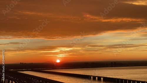 Glowing sunrise over Champlain bridge linking Montreal city to Brossard, time-lapse photo