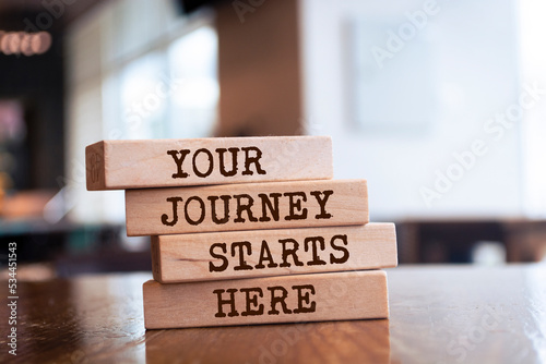 Wooden blocks with words 'Your Journey Starts Here'.