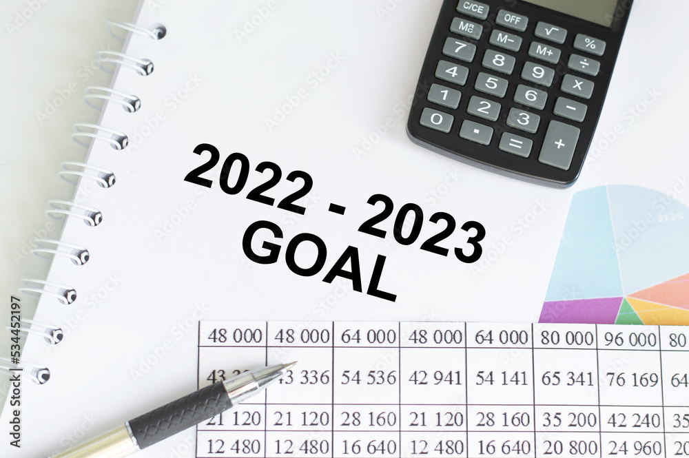 New year goals 2022 on desk. 2022 resolutions list with notebook, coffee cup and eyeglasses on wooden background. Goals, plan, strategy, business, idea, action concept. Top view New year goals 2022 on desk. 2022 resolutions list with notebook, coffee cup and eyeglasses on wooden background. Goals, plan, strategy, business, idea, action concept. Top view