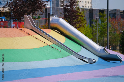 Children's slides on a colored playground in a city park