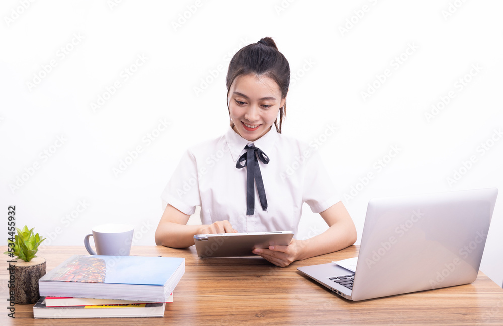 Asian female students taking an online class against a white background Asian female students taking an online class against a white background