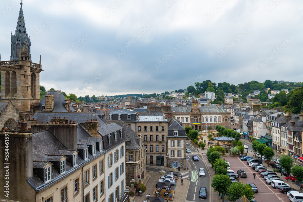 Aerial view of the city of Morlaix, Brittany, France, with its traditional buildings. Bell tower of the cathedral on the left. Overcasted sky on the background.
