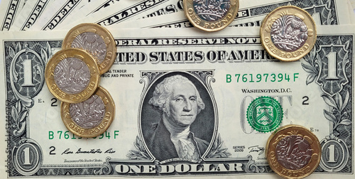 Billede på lærred American dollar bills with British pound coins overlaid - exchange rate concept