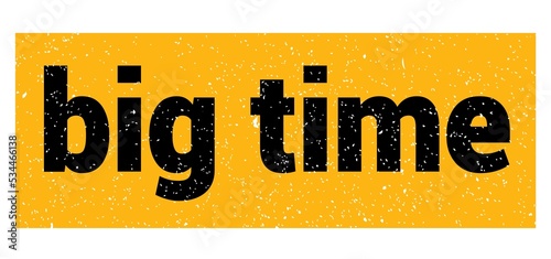 big time text written on yellow-black stamp sign.