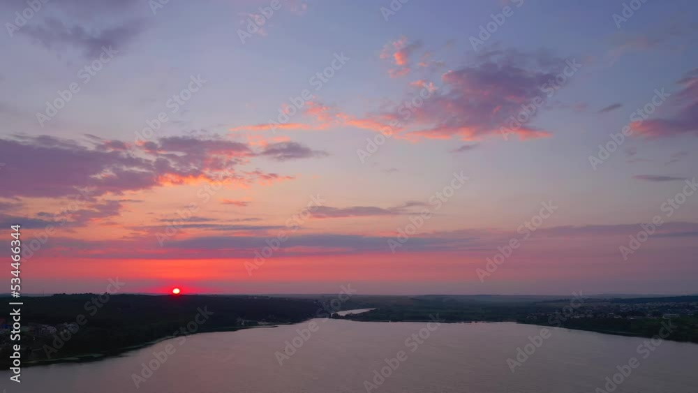 The sun sets over the horizon. Filmed in UHD 4k video.