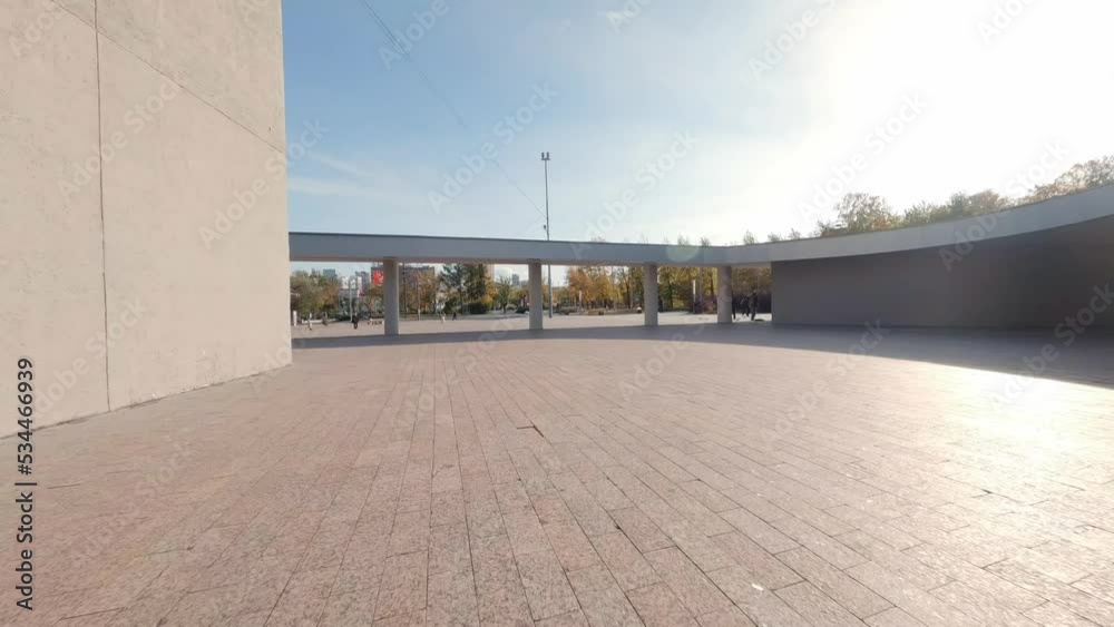 FPV drone view of Guys are skating on the square next to the modern building. Autumn sunny day. Yellow leaves on the trees
FPV drone view of Guys are skating on the square next to the modern building. Autumn sunny day. Yellow leaves on the trees