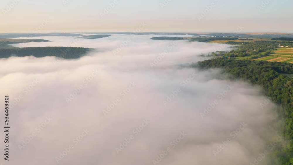 In the morning a thick white fog spreads through the valley. UHD 4k video. In the morning a thick white fog spreads through the valley. UHD 4k video.