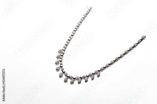 Elegant necklace with diamonds on white background