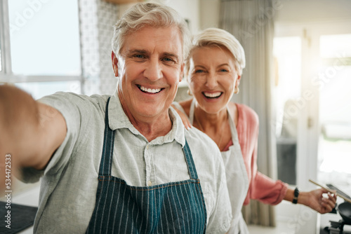 Selfie, senior couple and cooking in kitchen with smile, laugh and fun at their house prepare lunch together. Pov, elderly, man and woman baking in their home romantic, loving and bonding with food.