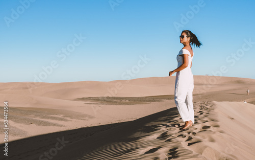 young woman at the dessert of Maspalomas sand dunes Gran Canaria during vacation at the Canary Islands. in Spain, Gran Canaria sand dunes photo
