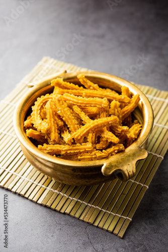 Bhajni chakli sticks or crunchy murukku snack made using diwali festival, favourite munching food photo