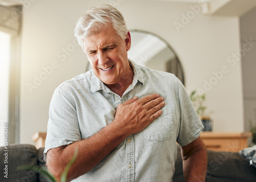 Senior man, heart attack and stroke at home for emergency health risk, breathing problem and cardiology accident. Sick elderly male with chest pain cancer, cardiovascular disease and heartburn injury photo