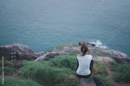 Wallpaper Mural Young Asian woman runner sitting to relax on top of the mountain with beautiful views. Enjoying freedom in life. Torontodigital.ca