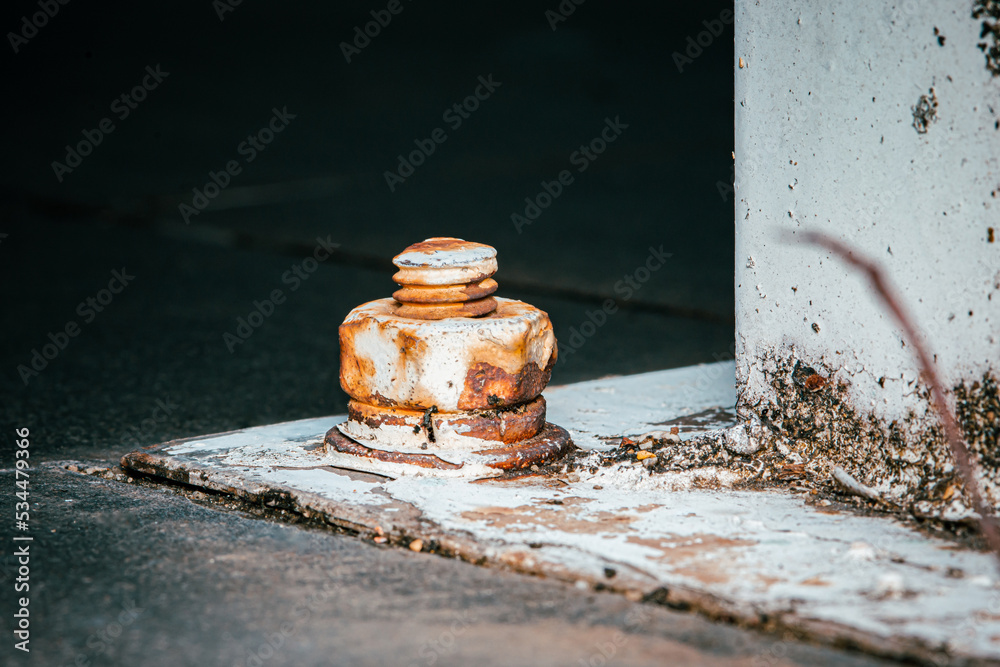 Corrosive rusted bolt with nut and metal plate on concrete floor, Grunge industrial construction, Selective focus, Close up. Corrosive rusted bolt with nut and metal plate on concrete floor, Grunge industrial construction, Selective focus, Close up.