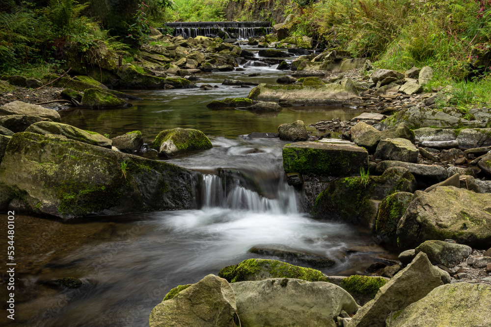 Waterfalls on a mountain stream in the forest at the beginning of autumn Waterfalls on a mountain stream in the forest at the beginning of autumn