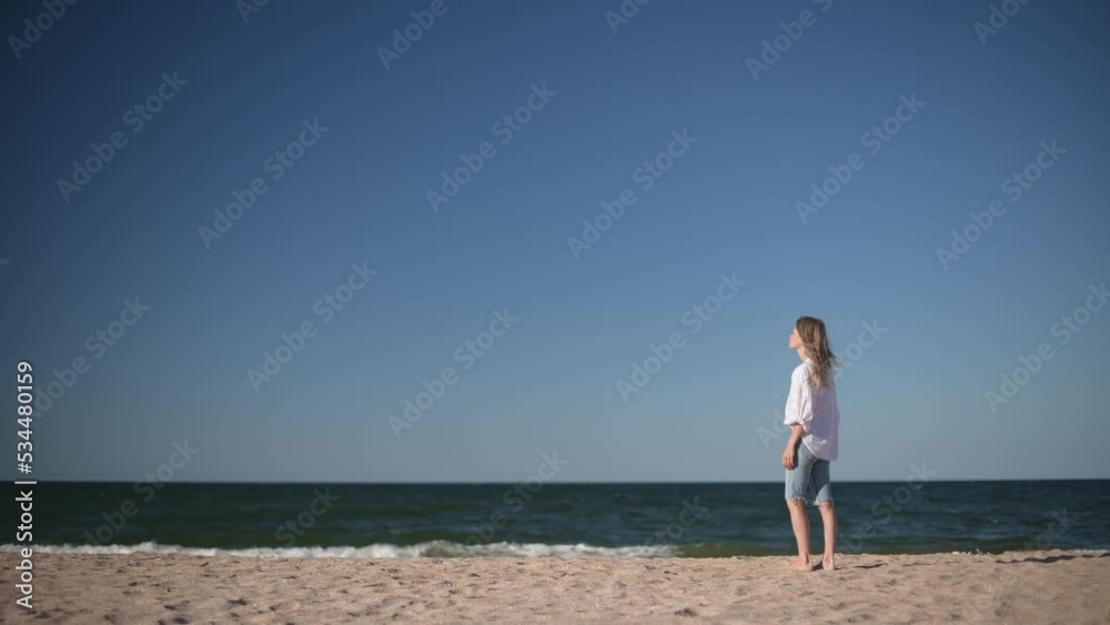 Romantic girl on sea background. Wind shakes long blond hair. Romantic girl on sea background. Wind shakes long blond hair.