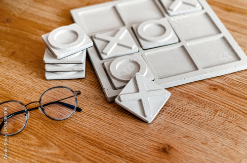 tic tac toe board game on wooden table. Cement material.