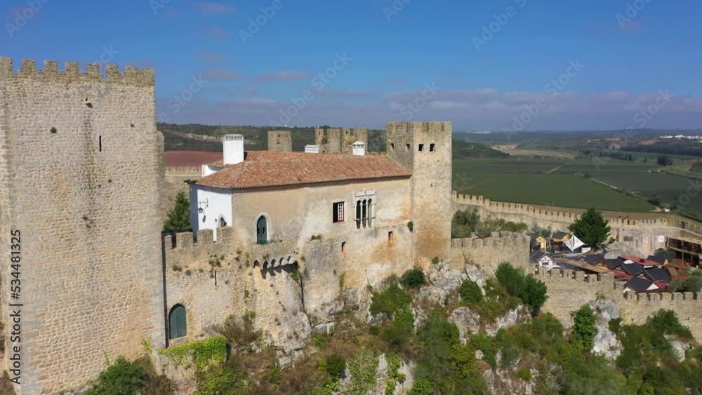 Aerial view around the Castelo de Óbidos fortress, in sunny Portugal - circling, drone shot Aerial view around the Castelo de Óbidos fortress, in sunny Portugal - circling, drone shot