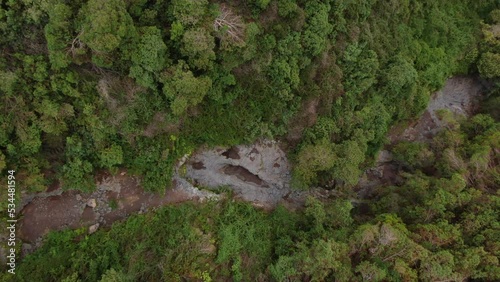 Drone ascending over a dry river bed in the Polipoli Springs State Recreation Park in Maui one of the wettest areas of Hawaii experiencing extreme drought.  photo