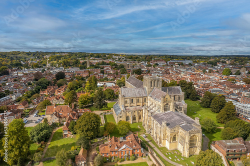 The drone aerial view of Winchester Cathedral and city, England. The Cathedral Church of the Holy Trinity, Saint Peter, Saint Paul and Saint Swithun, commonly known as Winchester Cathedral. © yujie