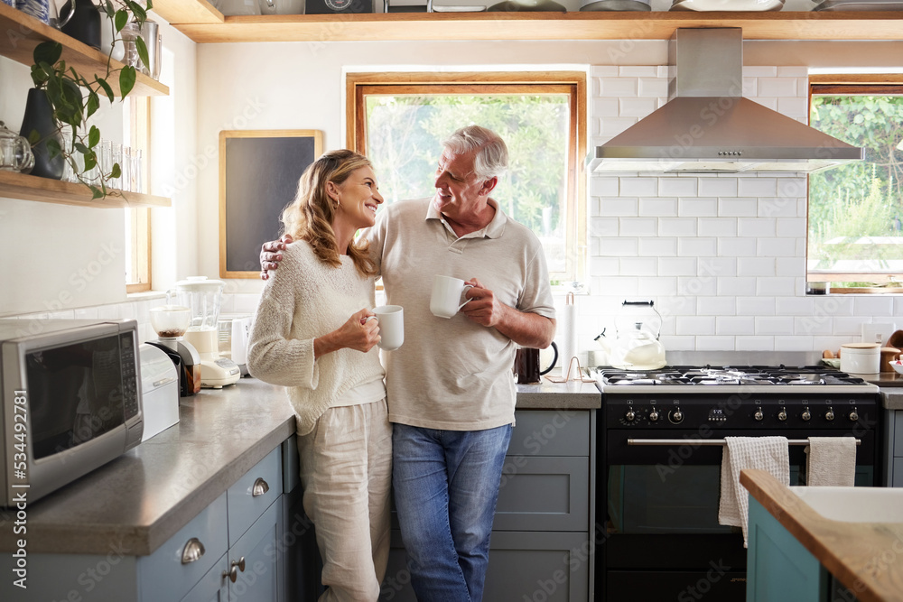 Senior, couple and drinking coffee with a love, marriage and happiness morning mindset at home. Happy smile and hug of a elderly woman and man with tea in a house kitchen together with quality time Senior, couple and drinking coffee with a love, marriage and happiness morning mindset at home. Happy smile and hug of a elderly woman and man with tea in a house kitchen together with quality time
