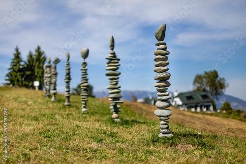 Row of stone johnnies on a rural landscape with cloudscape in the background photo