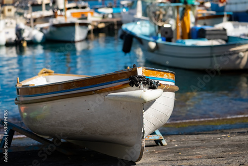 Colorful wooden fisher boat in the harbour Marina Grande on Capri Island Italy. Typical small rowing boats that bring tourists into the famous Blue Cave “Grotta Azzurra“, with blurred background. © ON-Photography