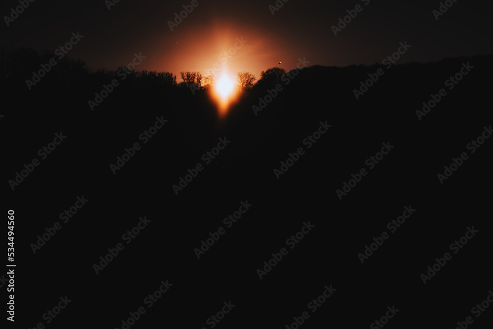the rays of the sun at sunset. a forest in silhouette at sunset. silhouette nature landscape with sunset the rays of the sun at sunset. a forest in silhouette at sunset. silhouette nature landscape with sunset