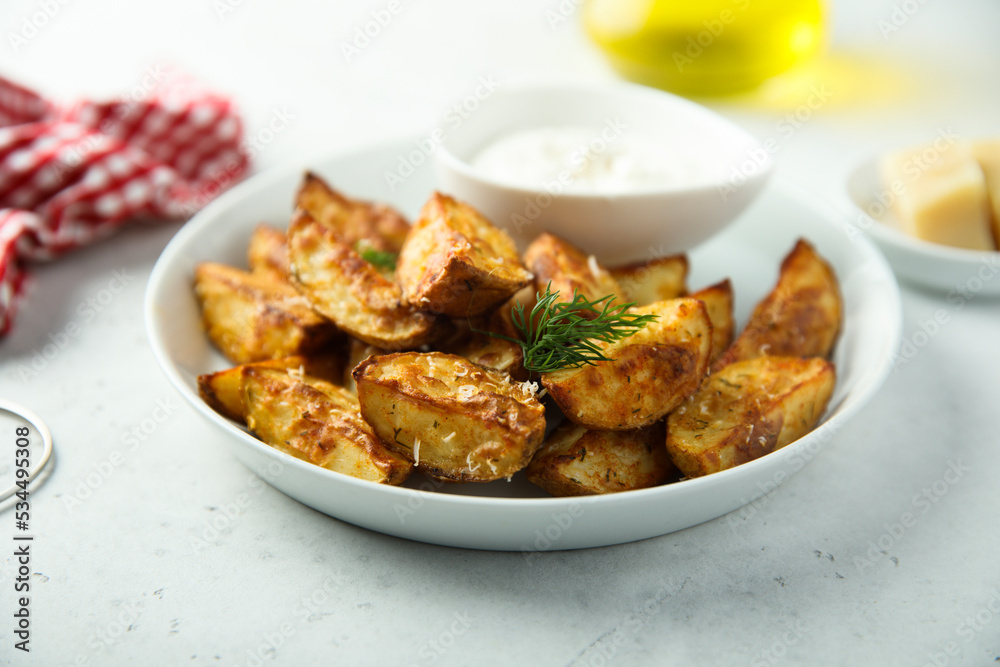 Roasted potato wedges with cheese and spices