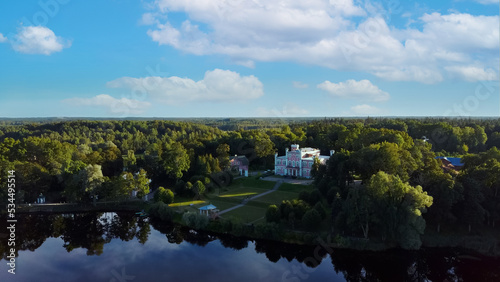 Aerial View of the Birinu Palace. Latvian Castle by Lake With Nice Garden, Drone Shot. Birini Manor, Vidzeme Region, Latvia. Sunny Autumn Day.. photo
