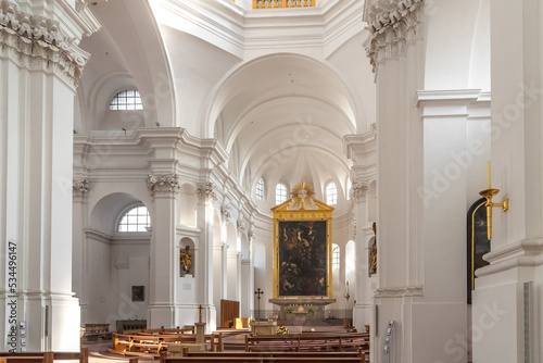 Nice interior view looking towards the apse with the monumental oil painting of the crucifixion in the parish church of St. John also called Stift Haug in Würzburg, Germany.
