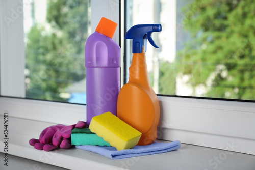 Cleaning supplies and tools on window sill indoors