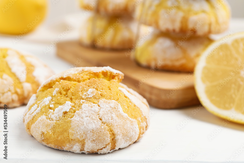 Tasty homemade lemon cookies on white wooden table, closeup. Space for text