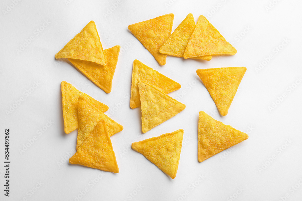 Flat lay composition of tortilla chips (nachos) on white background Flat lay composition of tortilla chips (nachos) on white background