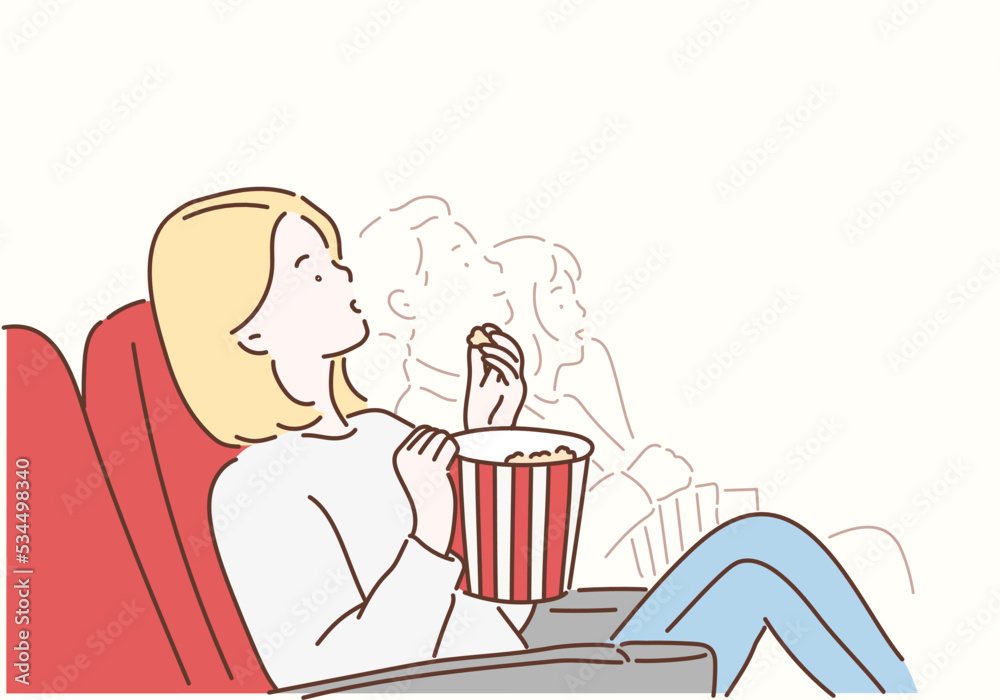 A young woman is watching a movie and is eating popcorn at the cinema. Hand drawn style vector design illustrations. A young woman is watching a movie and is eating popcorn at the cinema. Hand drawn style vector design illustrations.
