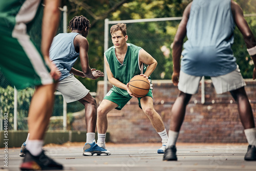 Basketball, team sport and competition for male athletes and players in training or professional match on an outdoor fitness court. Diversity, competitive and skill of men playing a ball game in USA © C Coetzee/peopleimages.com