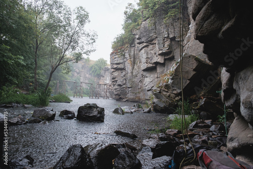 Climbing area Buksky canyon, rain on the Gorsky Tikich river near high granite rocks, Cherkasy region