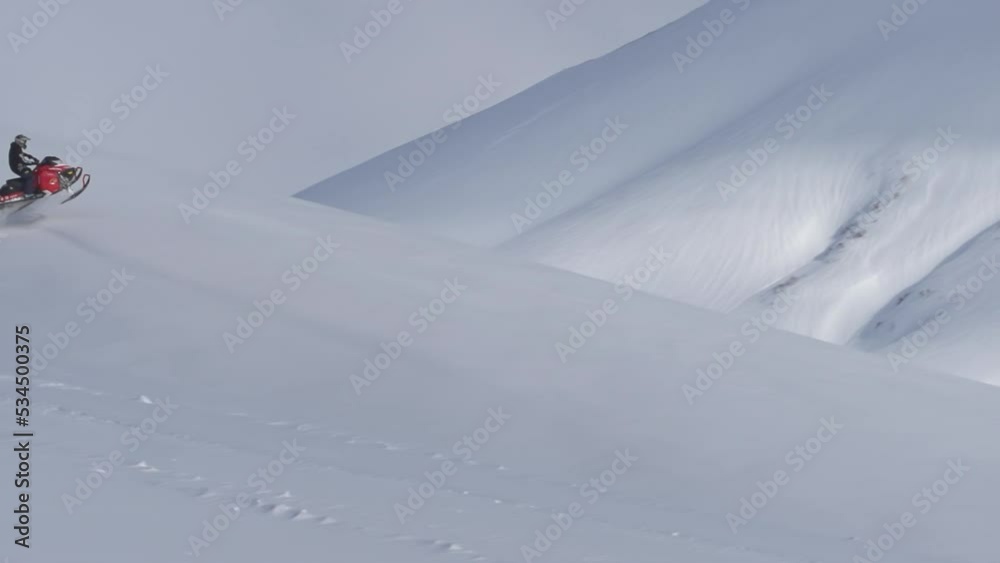 pro snowmobile extreme jump. 1000fps prores raw. on a clear background high in the mountains in flight on a mountain snowmobile pro snowmobile extreme jump. 1000fps prores raw. on a clear background high in the mountains in flight on a mountain snowmobile