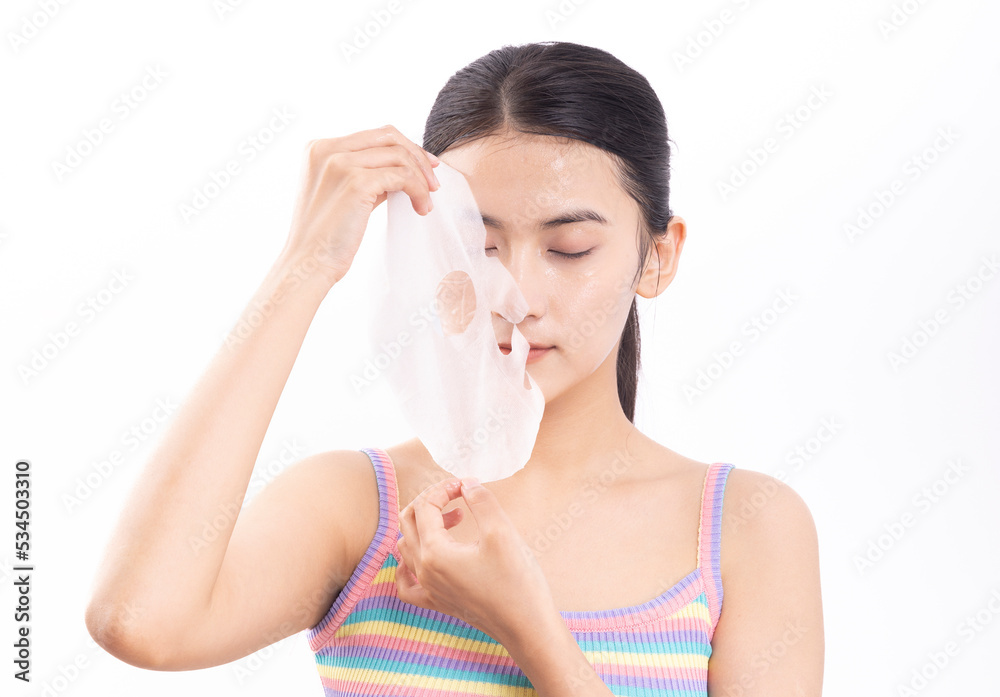 A young woman wearing a facial mask against a white background A young woman wearing a facial mask against a white background
