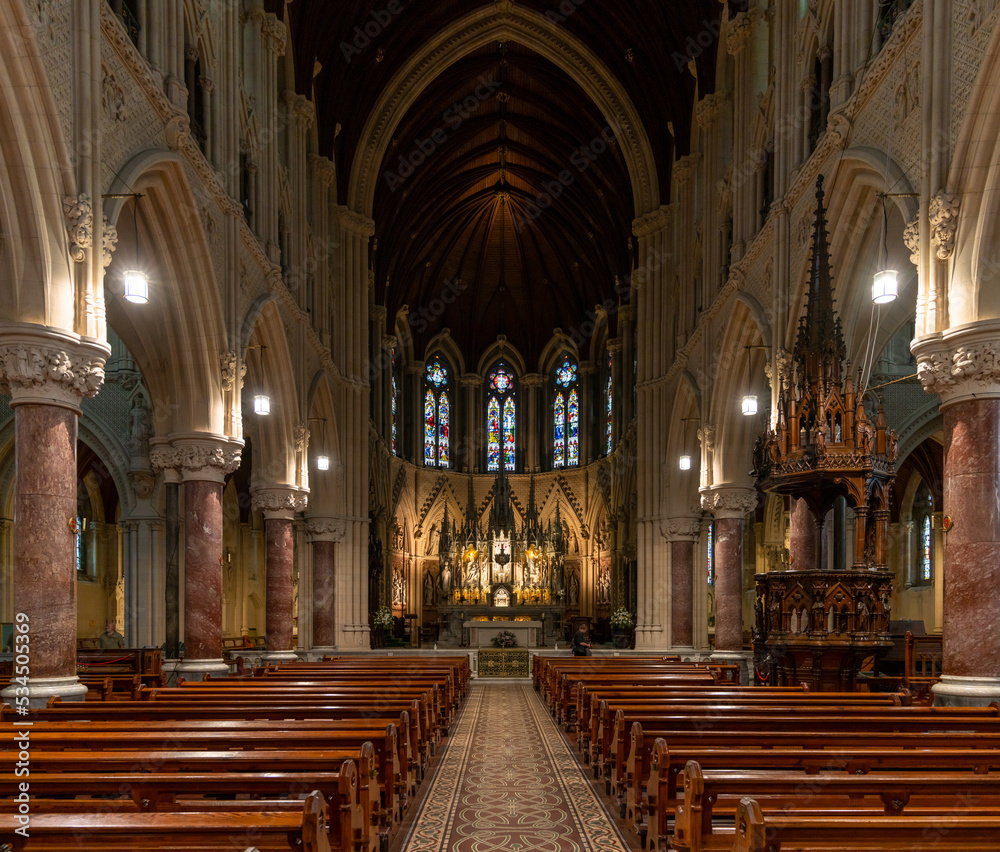 view of the central nave and altar with the elegant wooden pulpit in the Cobh Cathedral